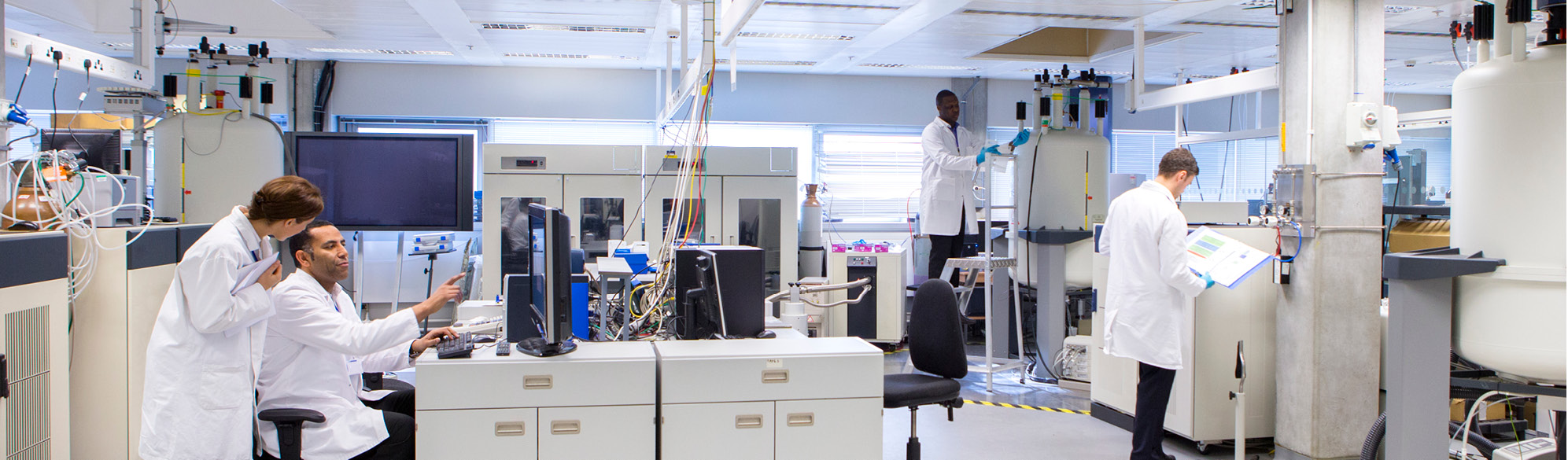 Workers process samples in a drug testing laboratory